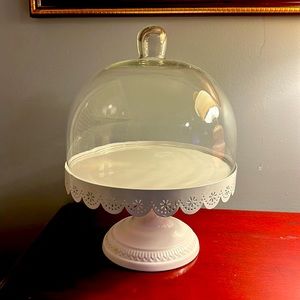 White enameled metal cake stand with glass dome